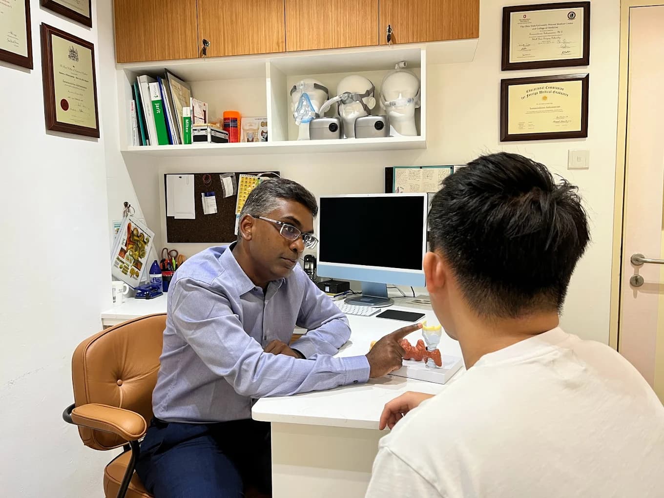Dr. Soma in consultation with a patient